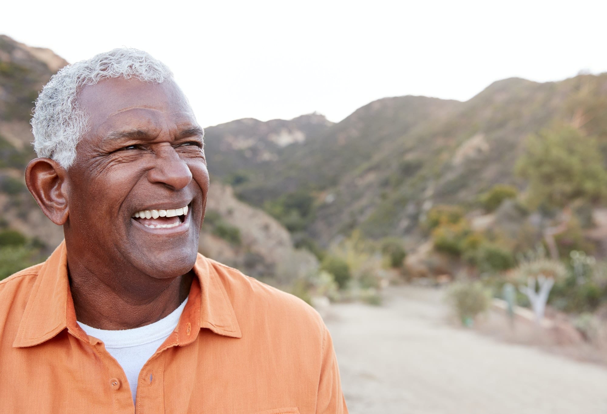 Portrait Of Smiling African American Senior Man Outdoors In Countryside