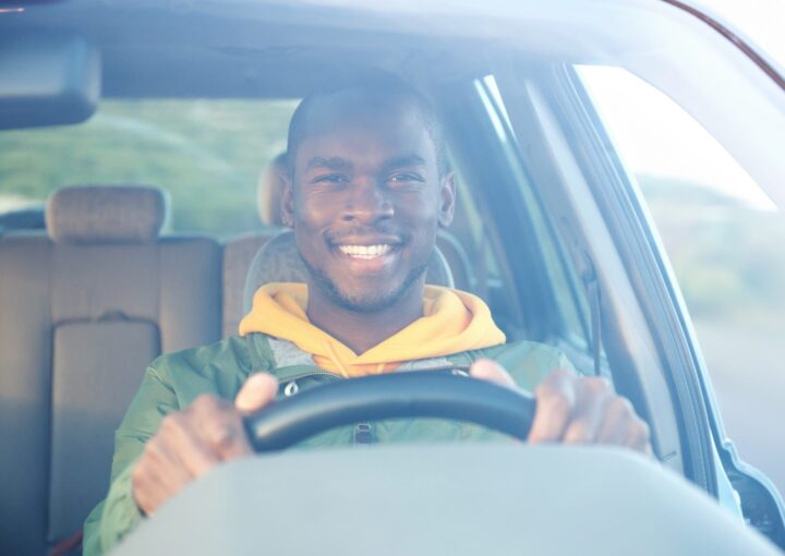 happy african american man driving car